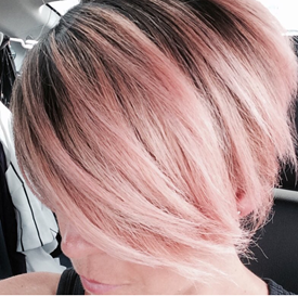 Model with dark roots and pink hair